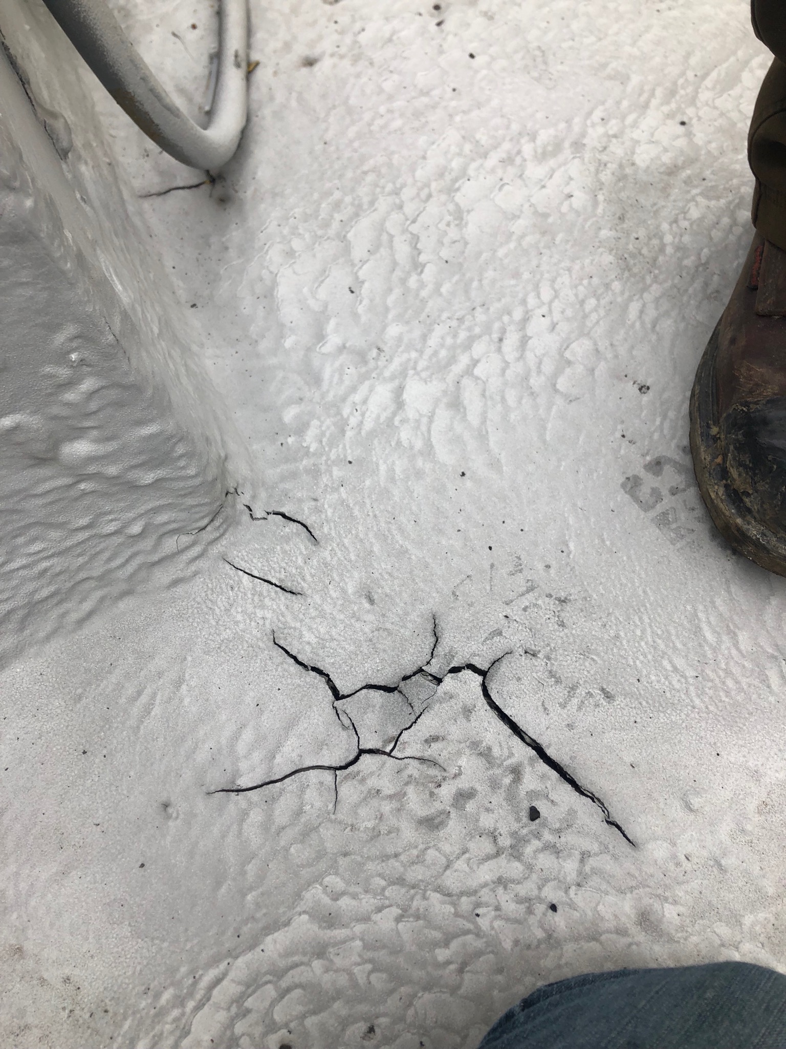 Polyurea coating applied over an aged asphalt roof surface