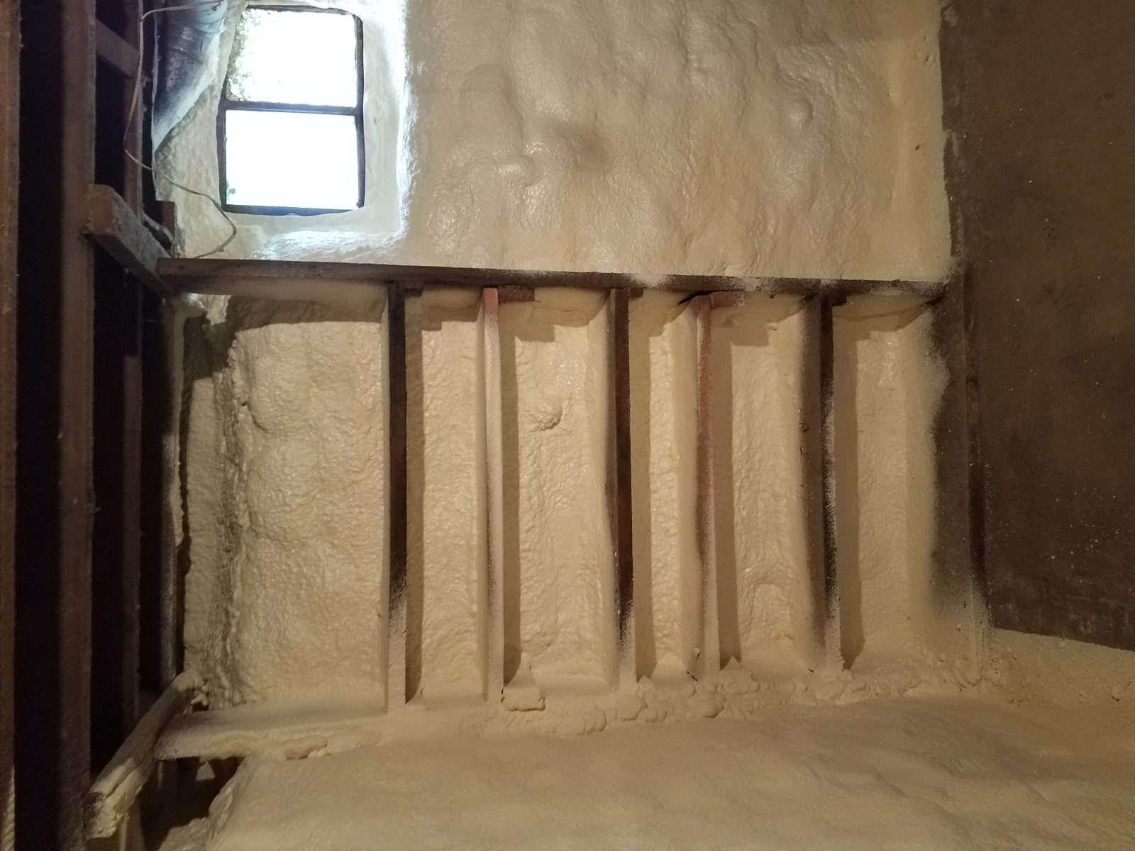 Closed-cell spray foam applied to a low-slope roof deck
