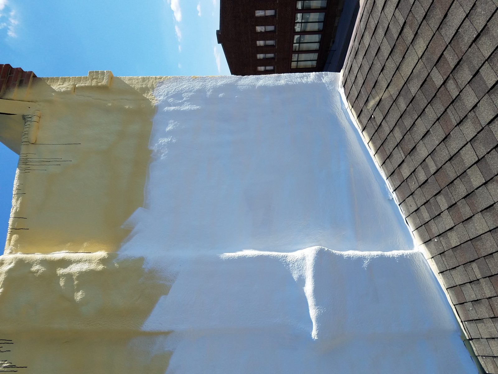 Spray polyurethane foam applied to an industrial roof before coating
