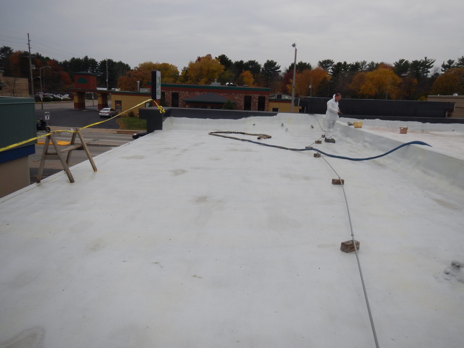 Metal panel roof with fastener lines and laps prepared for coating