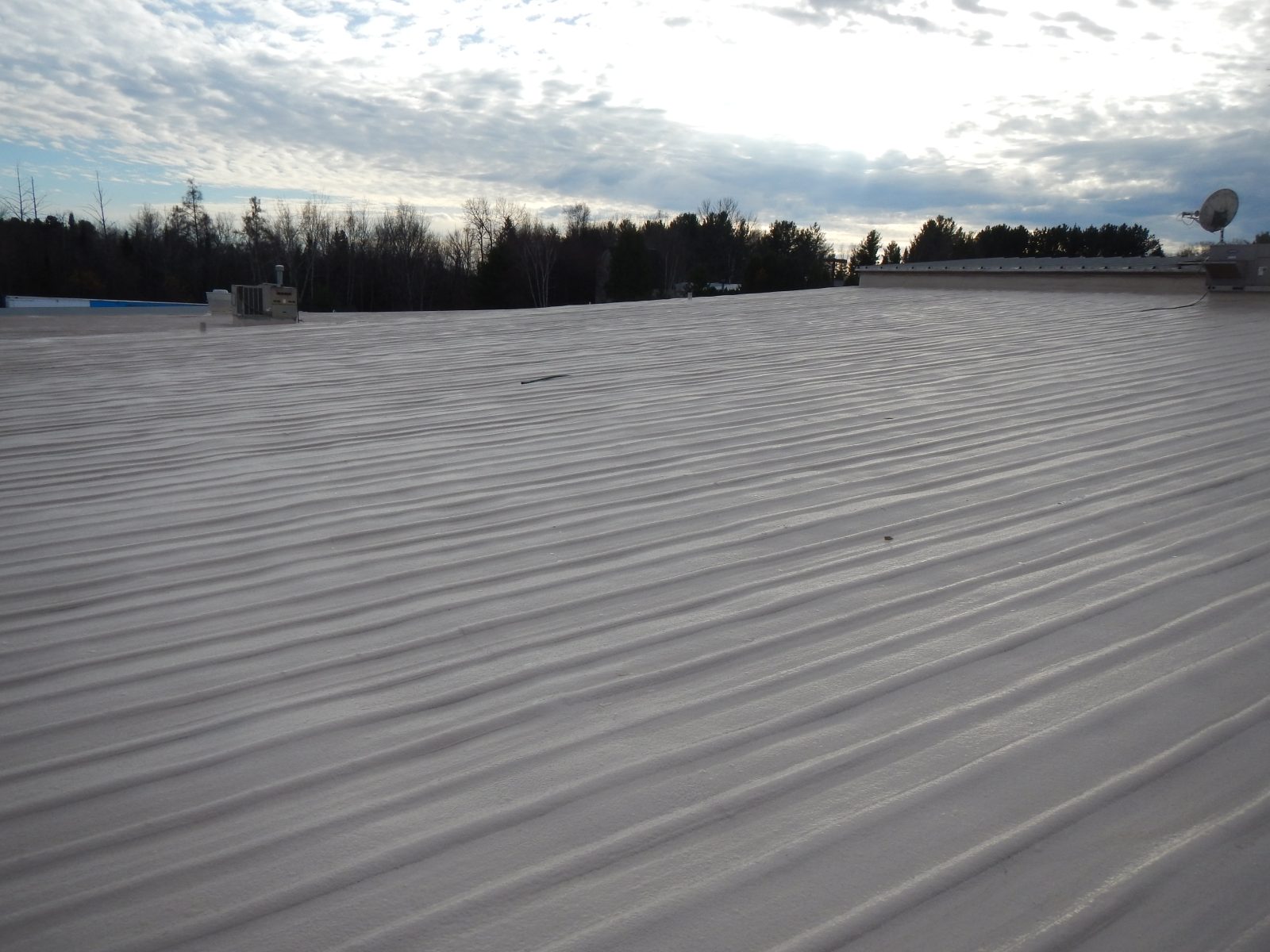 High-build polyurea applied to a rooftop traffic area